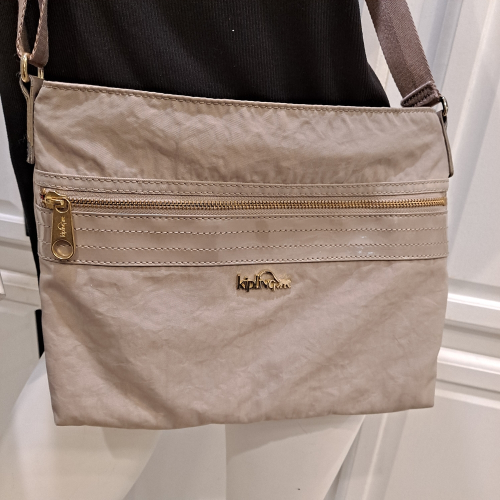 Kipling Beige Crossbody Bag with Gold Accents And Pink Interior